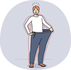 Smiling man in loose pants show weight loss