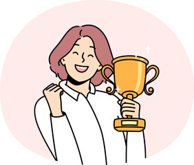 Smiling woman with gold trophy in hands