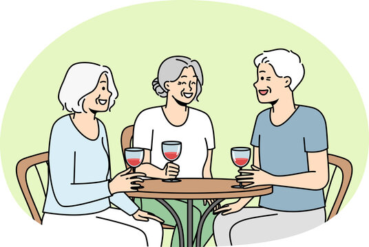 Smiling old people sit in cafe drink wine