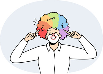 Fototapeta premium Portrait of male clown with rainbow hairstyle.