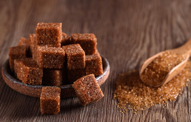 natural brown cane sugar on wooden background