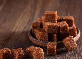 natural brown cane sugar on wooden background