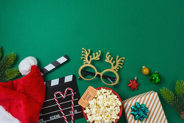 Top view composition for Christmas movie night and party concept with  popcorn, Santa hat,...