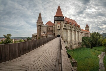 Fototapeta na wymiar a stone and wood path going through an ancient castle structure: Corvin Castle Hunedoara Romania