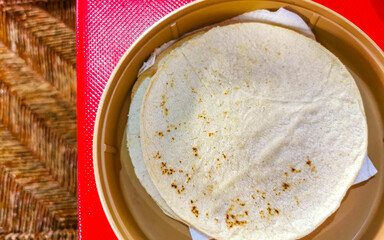 Tortillas in a bowl Plate on red table in Mexico.