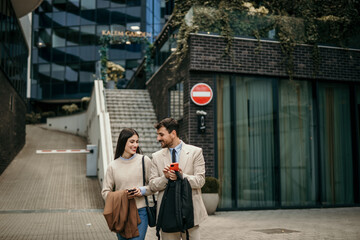 A couple of business persons talking outside of office building