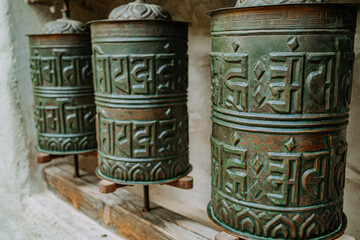 Buddhist prayer bronze drum close-up. Om padme hum. Asian symbol, religion.