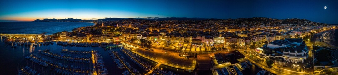 Night view of Cannes, a resort town on the French Riviera, is famed for its international film festival - obrazy, fototapety, plakaty