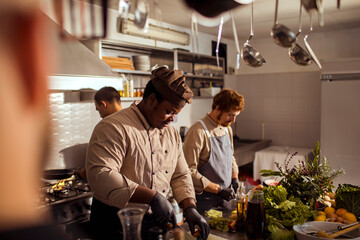 Young male chefs working in the kitchen