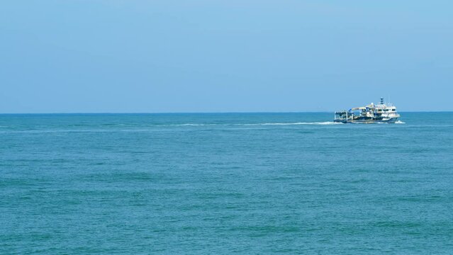 Fisherman Boat In The Black Sea. Lonely Fishing Boat Sails On The Sea With Nets On Board. Real time.