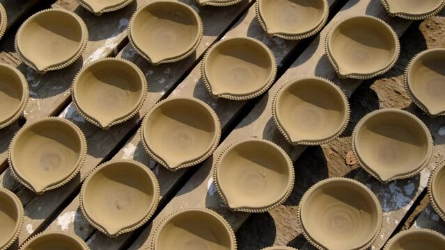 Indian potter making Diya (oil lamps) or earthen lamps for Diwali Festival with clay, Handwork craft. Pune, India.
