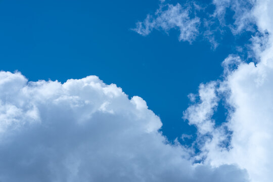 Big white clouds in a blue sky. Clear sky with clouds to replace the background. Nice sunny day.