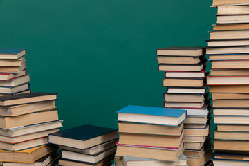 science education stack of books on a green background learning literacy