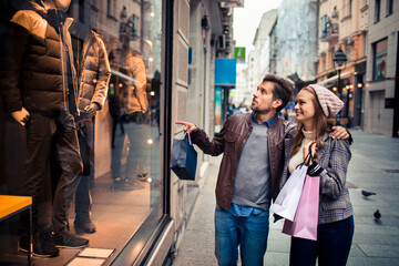 Portrait of a young couple with shopping bags in the city