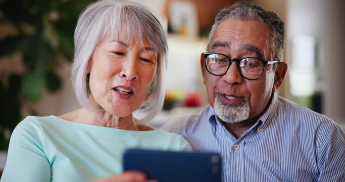 Mature man, woman and smartphone in video call with blow kiss, communication and connect in living room. Senior couple, technology and talking on live streaming, wave hello and online in family home