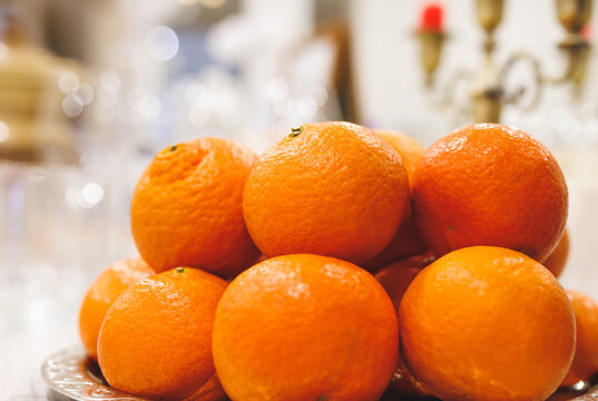 Several ripe juicy tangerines on a light background.