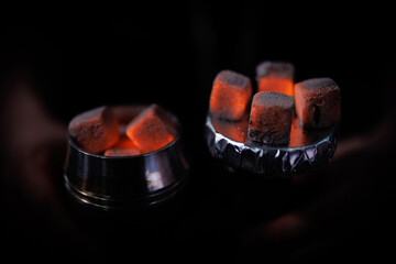 Beautifully smoldering coals for a hookah. Burning hookah coals. - obrazy, fototapety, plakaty
