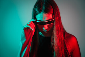 Curious futuristic transgender person using smart goggles