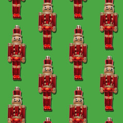 Repeating pattern of a Nutcracker soldier toy on a green background. Christmas pattern