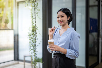 Business woman still thinking about work in a good mood during coffee break.