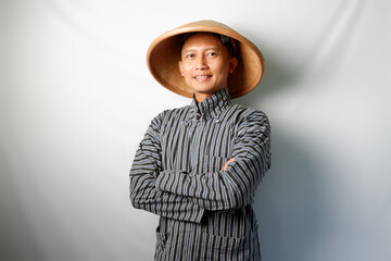 Asian farmer looking at camera with folded arm isolated on white background