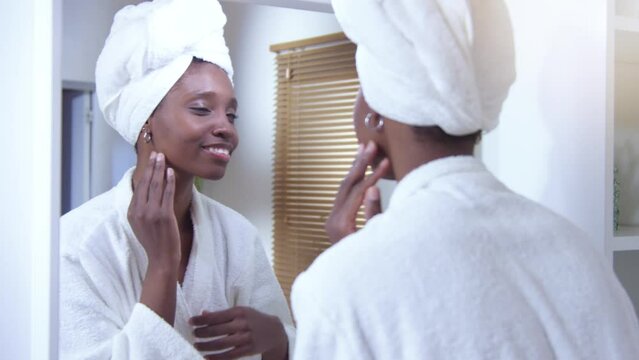 Black woman using facial beauty products morning self care. High quality 4k footage