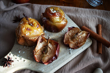 Baked apples with honey and cinnamon. on a wooden background. dessert
