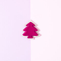 Beautiful Christmas tree on pastel pink purple background. Copy space for text. Minimal holiday concept. Flat lay.