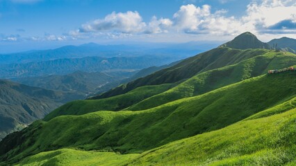 Mesmerizing Wugong mountain peaks covered with lush grass under the blue sky in China