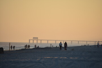 Pier on ocean with people