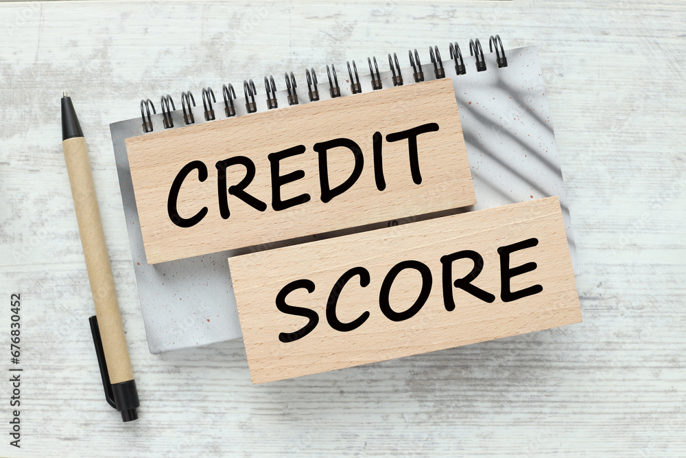 Poster credit score wooden blocks with text on a gray notepad