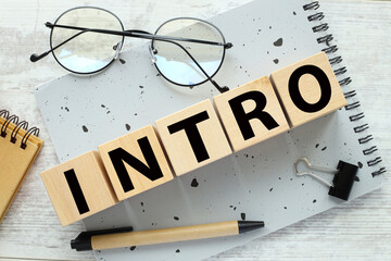 intro five cubes with text on a notepad. wooden blocks