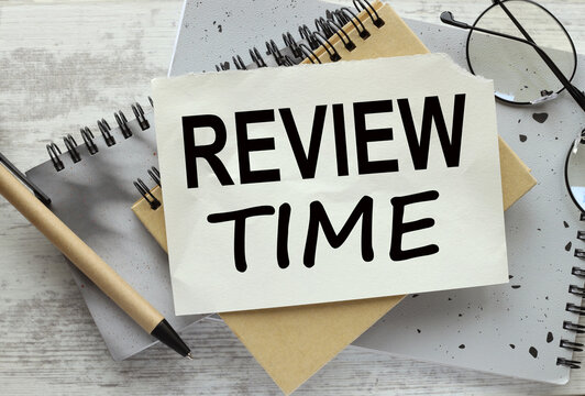 review time Business Concept. text on a page on a gray notepad on the table