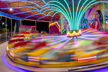The Tilt-A-Whirl ride gives riders a thrill at full speed at Old Town in Kissimmee (Orlando),...