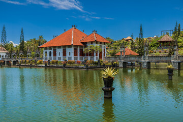 Water Palace Taman Ujung in East Bali. Balinese architecture with lake on sunny day