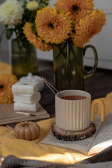 Autumn flowers of sunflowers and a cup of fragrant vitamin tea