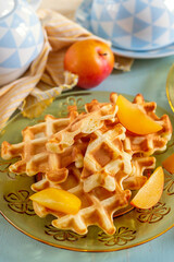 Sweet fluffy classic waffles served with plums - 676831657