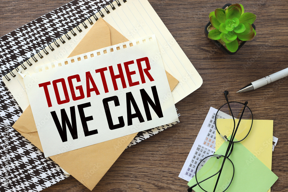 Poster together we can. open notepad on colorful notepad. dark work desk