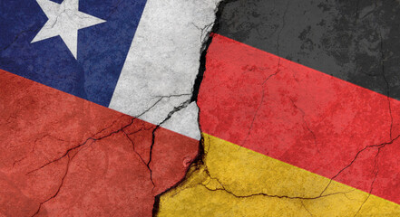 Chile and Germany flags, concrete wall texture with cracks, grunge background, military conflict concept