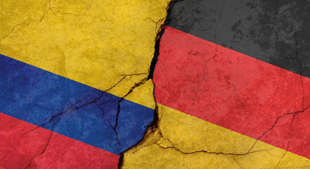 Colombia and Germany flags, concrete wall texture with cracks, grunge background, military conflict concept