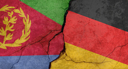 Eritrea and Germany flags, concrete wall texture with cracks, grunge background, military conflict concept