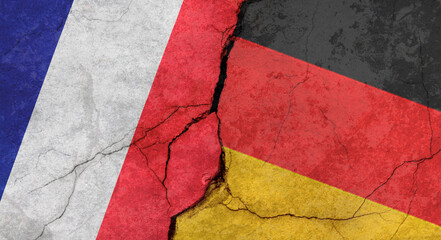 Flags of France and Germany, texture of concrete wall with cracks, grunge background, military conflict concept