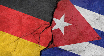 Germany and Cuba flags, concrete wall texture with cracks, grunge background, military conflict concept
