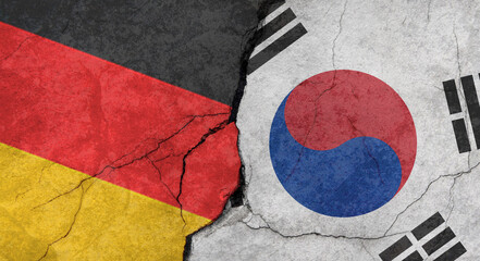 Germany and South Korea flags, concrete wall texture with cracks, grunge background, military conflict concept