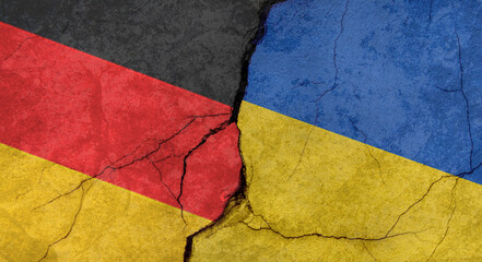 Flags of Germany and Ukraine, texture of concrete wall with cracks, orange background, military conflict concept