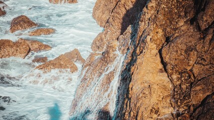 Rock wall of a rushing rapids at a river