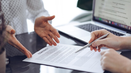 Businesswoman lawyer pointing into contract special points admitting something for colleague or...