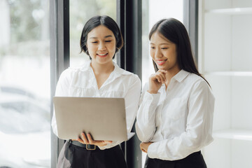 Group of confident business people point to graphs and charts to analyze market data, balance sheet, account, net profit to plan new sales strategies to increase production capacity.