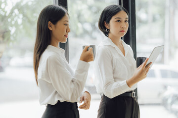 Obraz premium Asian woman in startup company office with happy expression, businesswoman executive and investor in business and stock, management of new generation concept. Start-up company management concepts.
