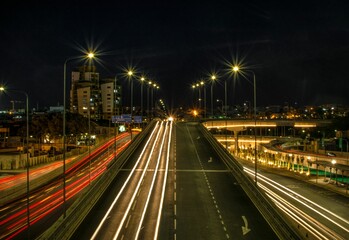 Fototapeta na wymiar Long exposure shot of the city colorful lights at night and traffic with long exposure highway